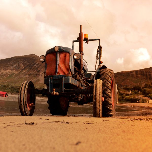 Old vintage tractor on Trefor beach in Wales.  Used by fisherman to transport their catch.